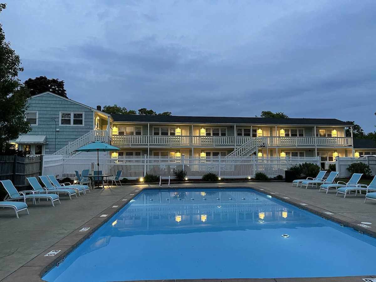 Pool illuminated at dusk at The Escape Inn