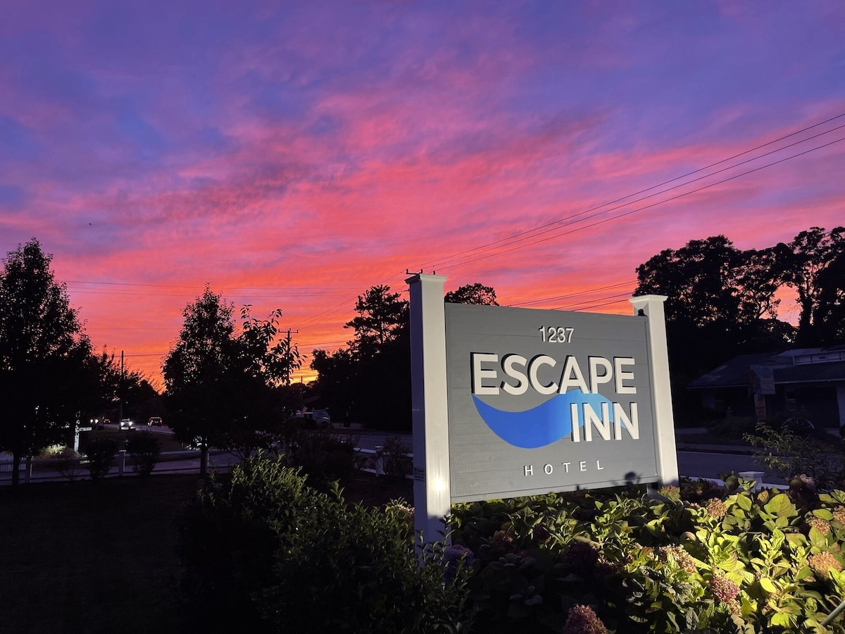 The Escape Inn sign at sunset